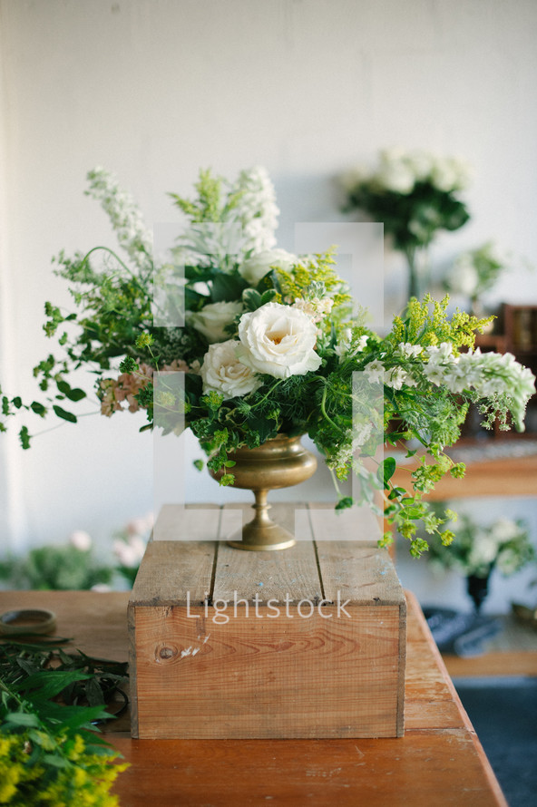 centerpiece floral arrangement on a crate 