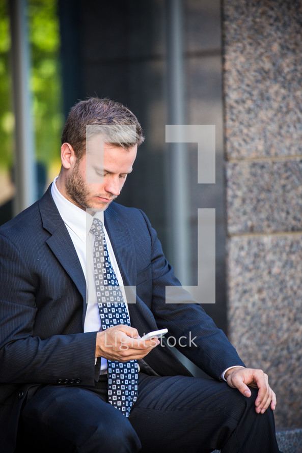 businessman checking his cellphone 