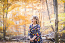 a girl child playing outdoors in fall 