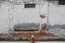 fire hydrant in front of an old brick wall 