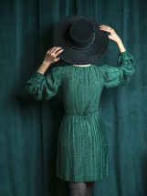 woman in a green dress and green hat 