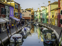 Colorful buildings along canal with boats