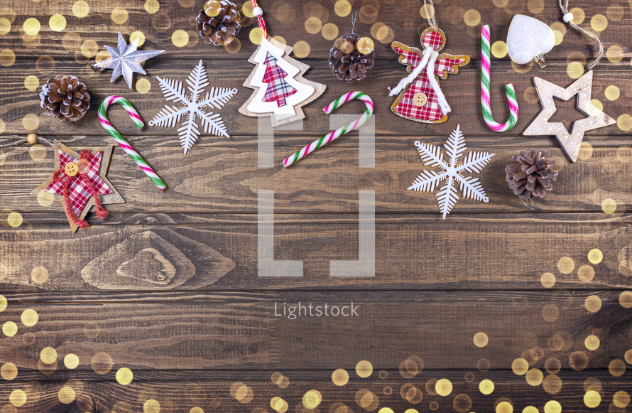 Christmas decorations in a frame on a wooden background with bokeh lights