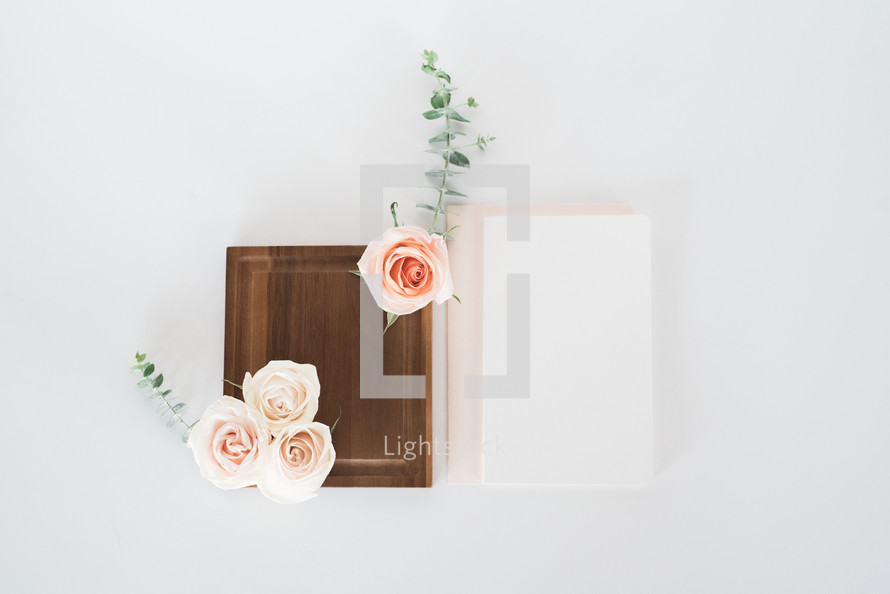 pink roses, wooden tray and stationary 
