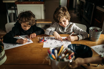 children coloring a coloring page at home 