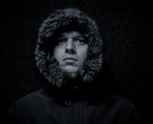 face of a man in a fur lined hood