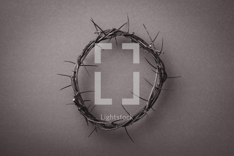 Crown of thorns over grey background. Top view. Copy space. Christian Easter concept. Crucifixion of Jesus Christ. He risen and alive. Jesus is the reason. 