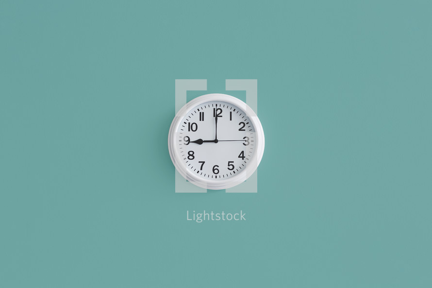 White clock on teal background