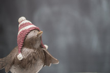 bird figurine in a winter hat 
