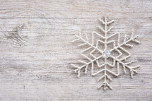 snowflake decoration on wood background 