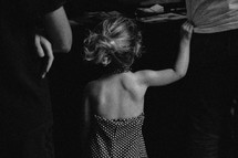 young girl tugging on father's shirt 