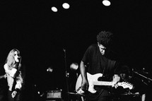 a man on stage playing a guitar 