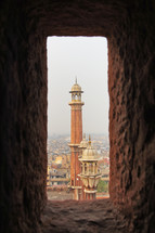 viewing towers of a mosque through a window