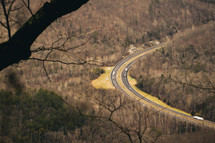 aerial view above a curve in a road 