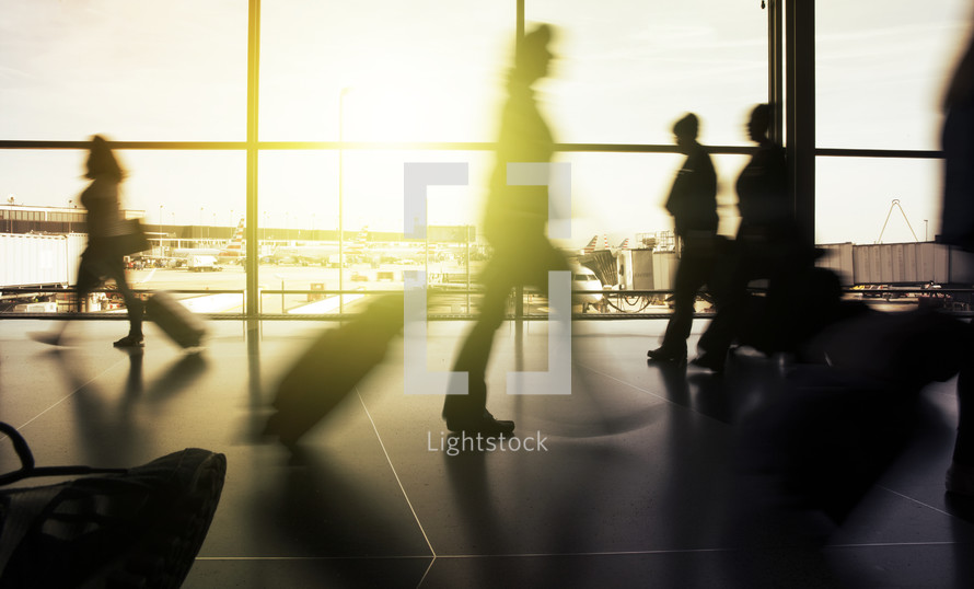 shadows walking through an airport terminal 