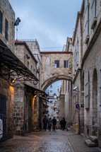 people walking on cobblestone streets in Jerusalem 