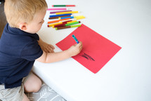boy coloring with markers 