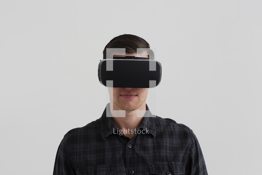 A young man wearing a virtual reality headset.