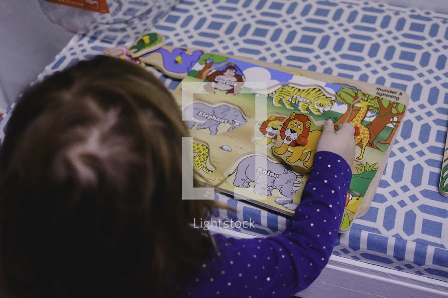 a toddler building a puzzle 