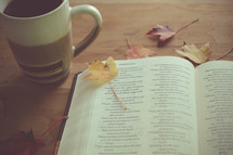 open Bible, coffee cup and fall leaves 