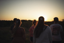 youth group outdoors at sunset 