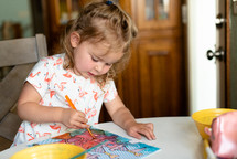 toddler girl painting with watercolors 