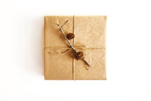 gift box wrapped with twine and pine cones 