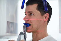 a man getting x-rays at the dentist