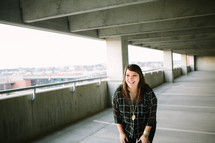 A woman standing in a parking garage 