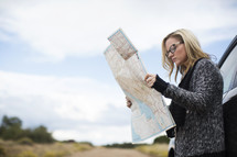 a woman looking at a road map 