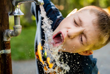 a boy drinking water 