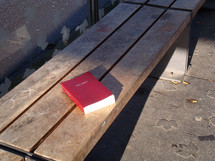 bible on a bench at a bus stop, 

bible, bench, stop, bus stop, waiting, tram, station, streetcar, trolley, transportation, way, bus