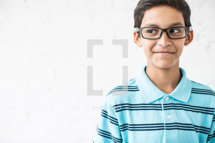 boy child wearing reading glasses and a smirk 