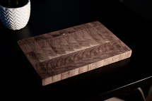handmade oak cutting board on a black background