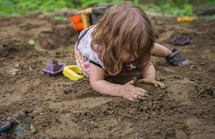 a kid playing in dirt 
