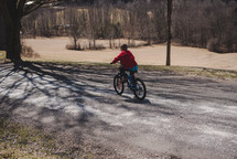 a boy riding a bicycle 