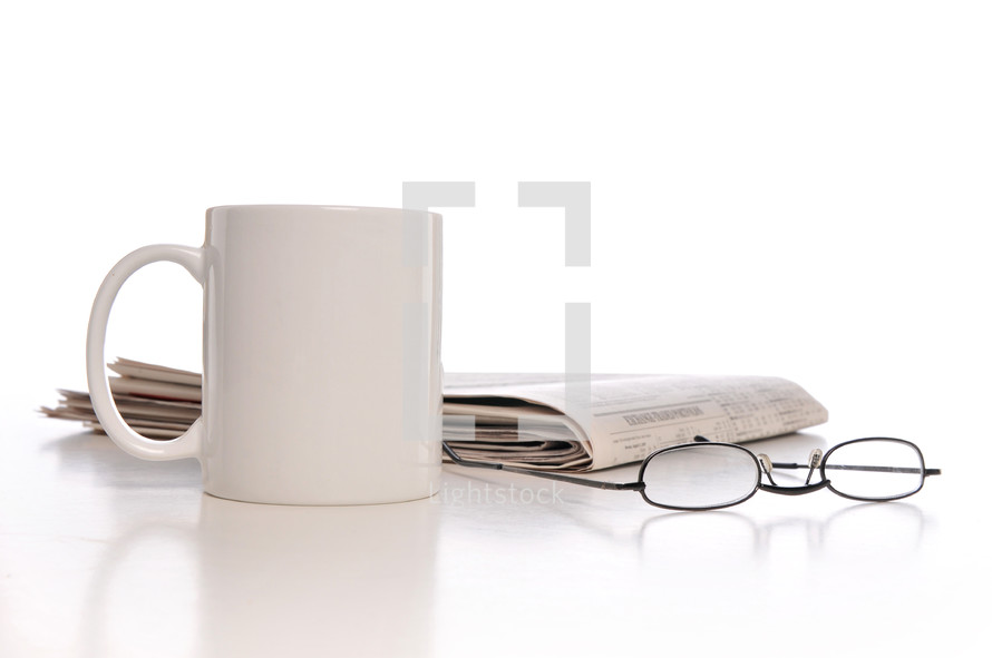 coffee mug, newspaper, and reading glasses 