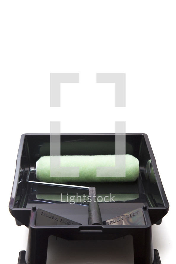 paint roller and paint tray on white 