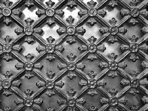 wrought-iron ornamental lattice, 
wrought-iron, ornament, decoration, lattice, monochrome, window, iron, grid, bars, latticework, flower, floral, ornamental, adornment, black and white, grey, dirty, dusty, glass