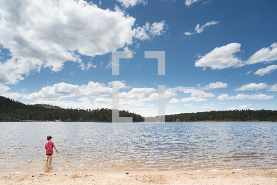a child standing in a lake 
