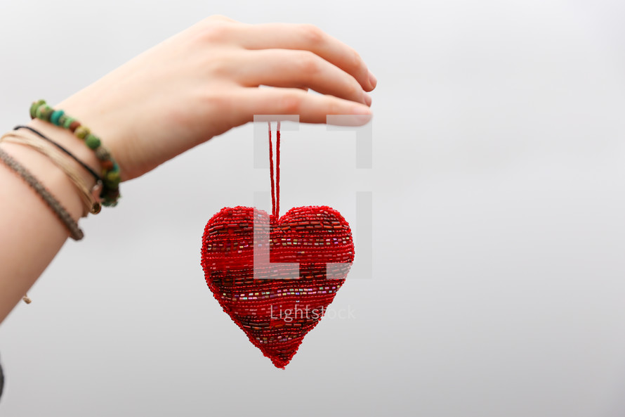 woman holding a heart ornament 