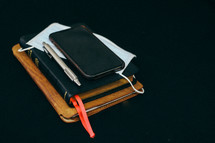 journal, mask, cellphone, and Bible 