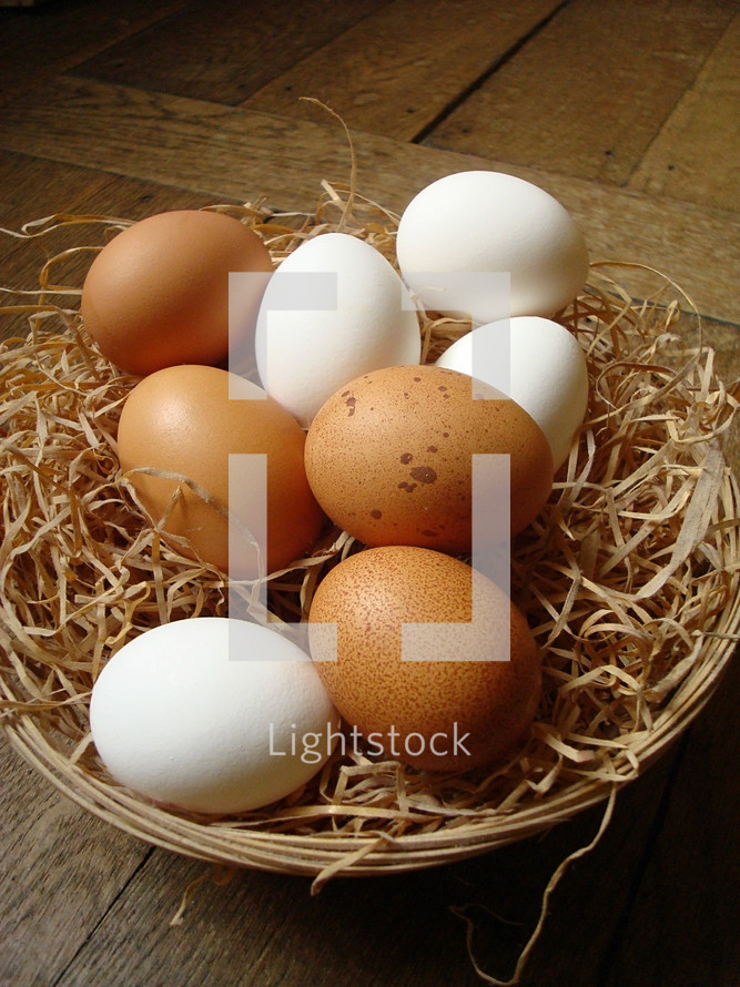 White and brown eggs in a basket