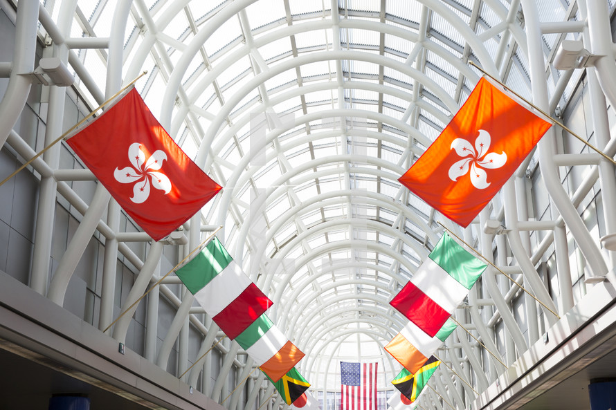 flags of various nations in an airport walkway. 