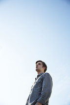 A young man looking toward the sky.