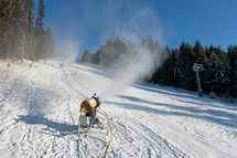 Snow blowers on a ski slope