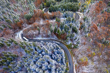 aerial view over a winding winter road 