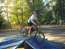 child with a bike on a ramp 