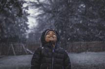 a kid in falling snow 
