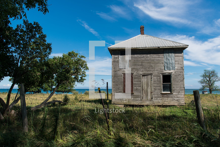 abandoned house along a shore 